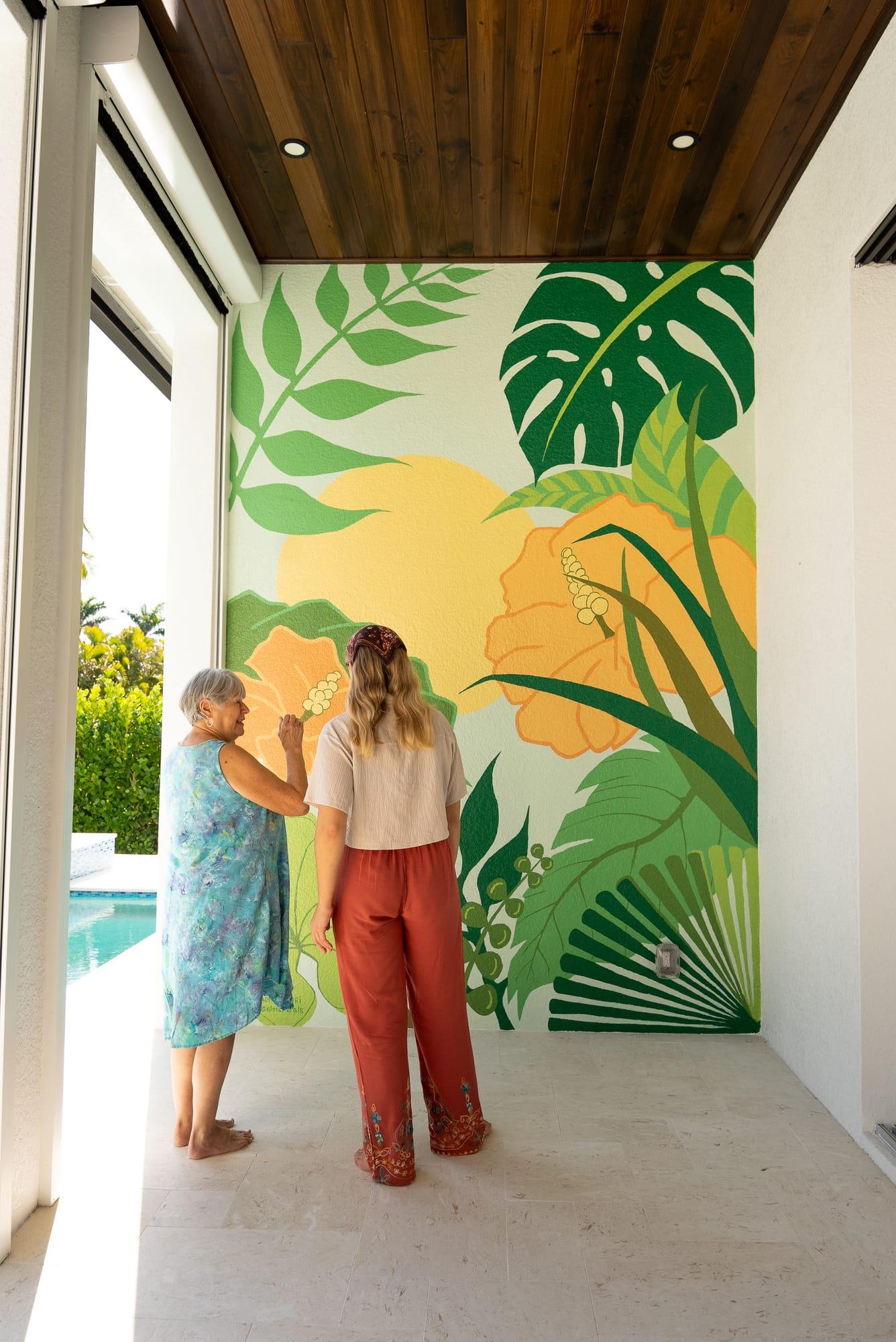 Homeowners admiring their new hand-painted mural
